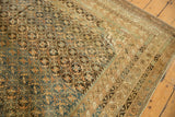 Antique Caucasian carpet border corner with complex geometric patterns in abrased gold, ivory, and blue.