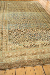 Secured geometric border, intricate starburst pattern, and abraded tones on an antique Caucasian rug.