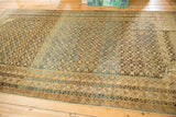 Antique Caucasian rug's intricate geometric borders and starburst field with abashed blue, gold, and ivory tones.