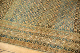 Antique Caucasian carpet starburst design and multi-band geometric borders in blue and gold.