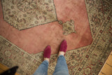 Dusty blush rose field, sharp stepped contour, and Herati vine spandrel of a vintage Tabriz.