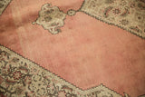 Textured dusty blush rose field with sharp serrated contour and antique ivory Herati spandrel.