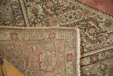 Tightly hand-knotted foundation and fringed edge of a distressed vintage Tabriz rug.