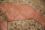 Distressed dusty blush rose field, sharp stepped contour, and Herati border motif.