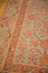 Distressed Khotan runner with pale tangerine germinating pomegranate motif and detailed border.