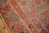 Distressed Khotan runner edge, tangerine border, faded pomegranate motifs on pale gray.