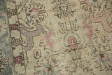 Distressed vintage Tabriz detail: worn ivory pile, blush and aqua floral blossoms.