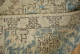 Vintage distressed Tabriz rug's hand knotted foundation and worn aqua blue pile.
