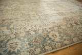 Distressed vintage Tabriz carpet: faded floral blossoms in ivory field, aqua blue palmette border.