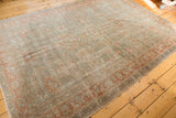 Distressed vintage Sivas carpet with terracotta lotus and serrated leaf motifs, faint foundation showing.