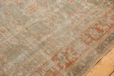 Textured distressed Sivas carpet with faded terracotta lotus and sea foam green palmette motifs.