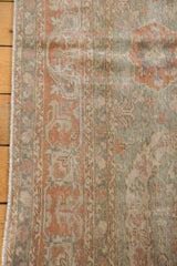 Distressed vintage Sivas carpet pile with terracotta floral motifs, seafoam, and fringe.