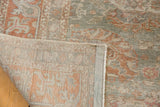 Distressed Sivas carpet pile with dusty green and terracotta, showing even wear and faint foundation.