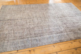 Vintage distressed Turkish Sparta carpet texture with subtle motifs in muted silver and slate blue.