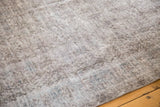 Distressed vintage Turkish Sparta carpet pile with muted silver and slate blue motifs.