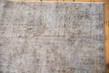 Vintage distressed Sparta carpet showing worn pile texture in muted silver and blue tones.