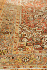 Distressed Mehrivan carpet's terracotta, silver, and beige geometric pattern with low pile.