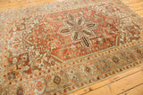 Distressed Mehrivan carpet's low pile, featuring geometric serrated leaves in terracotta and ivory.