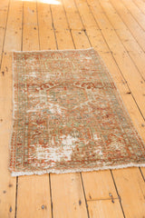 Distressed Karaja rug: visible foundation, geometric motifs, and rust-green colors.
