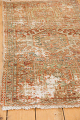 Distressed Karaja rug with decorative worn terracotta pile, geometric details, and exposed foundation.