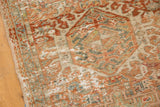 Distressed Karaja rug displaying geometric patterns and textured wear in terracotta and ivory.