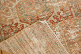 Distressed vintage Karaja rug corner showing worn terracotta pile and tightly woven foundation.