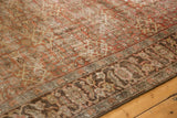 Distressed pile texture of vintage Mahal carpet's terracotta Herati field and detailed border.