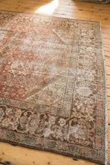 Distressed vintage Mahal carpet corner, showing its wide ornate border and fringed edge.