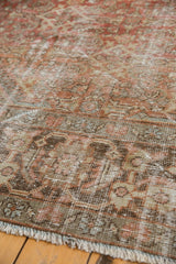 Distressed vintage Mahal carpet border and fringe in terracotta, chestnut, and slate tones.