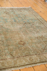 Textured distressed Hamadan rug pile showing mostly even wear, faint foundation, seafoam green and beige hues.