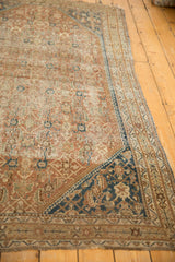 Antique Shiraz rug corner, featuring worn Herati field and dark navy spandrel.