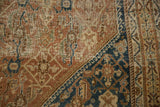 Antique Persian Shiraz rug, close-up showing worn Herati motif and exposed foundation.