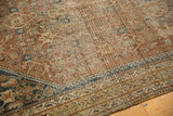 Antique Shiraz rug border with intricate patterns, aged copper, navy blue, and visible knot heads.