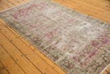 Close-up of distressed Sivas rug with artful wear, exposed foundation, and faded floral pattern.