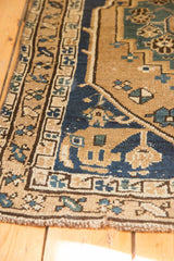 Northwest Persian antique rug's geometric primitive renderings, navy border, and wear.