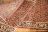 Folded vintage Mir Serbend rug showing brick red boteh pattern, low pile, and hand-knotted reverse.