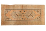 Distressed vintage Oushak runner with apricot peach, silver medallions, and floral border.