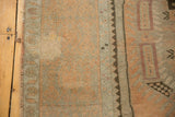Detail of distressed Oushak runner showing soft apricot peach pile and subtle pinwheel design.