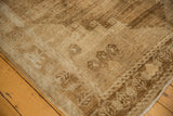 Distressed vintage Oushak rug corner showing primitive patterns and heavily abrashed texture.