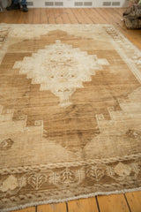 Distressed vintage Oushak rug border with primitive motifs and abrash texture.