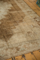 Distressed vintage Oushak carpet with primitive motifs, low pile, and heavy abrash.