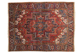 Vintage Heriz carpet; geometric star medallion, scrolling floral vinery in red, blue, ivory.