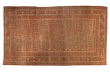 Vintage Belouch carpet, madder root red with pale charcoal serrated geometric plant motif.
