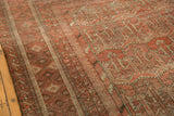 Serrated geometric plant motifs and multi-stripe border details on a vintage Belouch carpet.