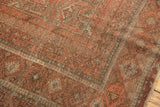 Intricate multi-stripe borders and serrated geometric motifs on the Belouch carpet.