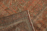 Madder root red germinating plant motif on Belouch rug pile, revealing fringe and hand-knotted reverse.