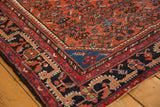 Low pile cherry red Herati motif field and dark navy geometric border on vintage Malayer rug.