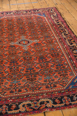 Vintage Persian Malayer rug corner, displaying an even low pile Herati motif and detailed dark navy border.