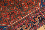 Cherry red field and dark navy border with intricate Herati motif on a vintage Malayer rug.
