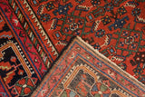 Vintage Malayer rug corner, revealing cherry red Herati pattern and hand-knotted reverse.